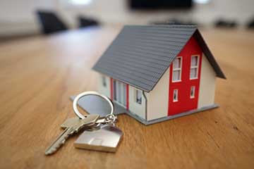 making an offer on a house banner showing a model house with key