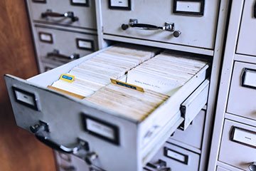 Searches when buying a house banner showing an old cabinet with files